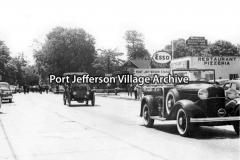 verso: "July 4, 1952; Main Street, south of the LIRR tracks, Port Jefferson Station; Win Hughes in 1912 Everitt"